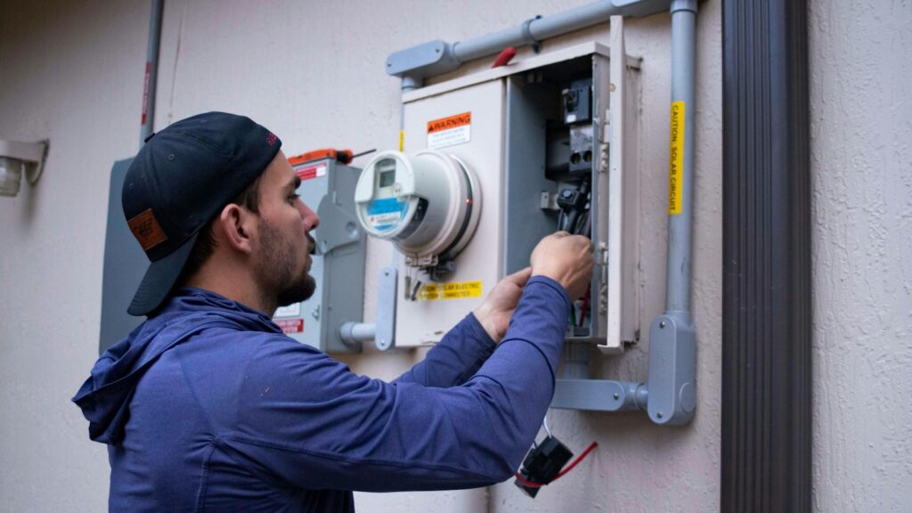 Electrician working on an electrical meter panel