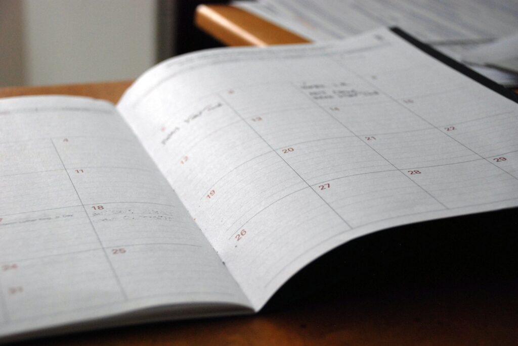Open monthly planner on a wooden desk