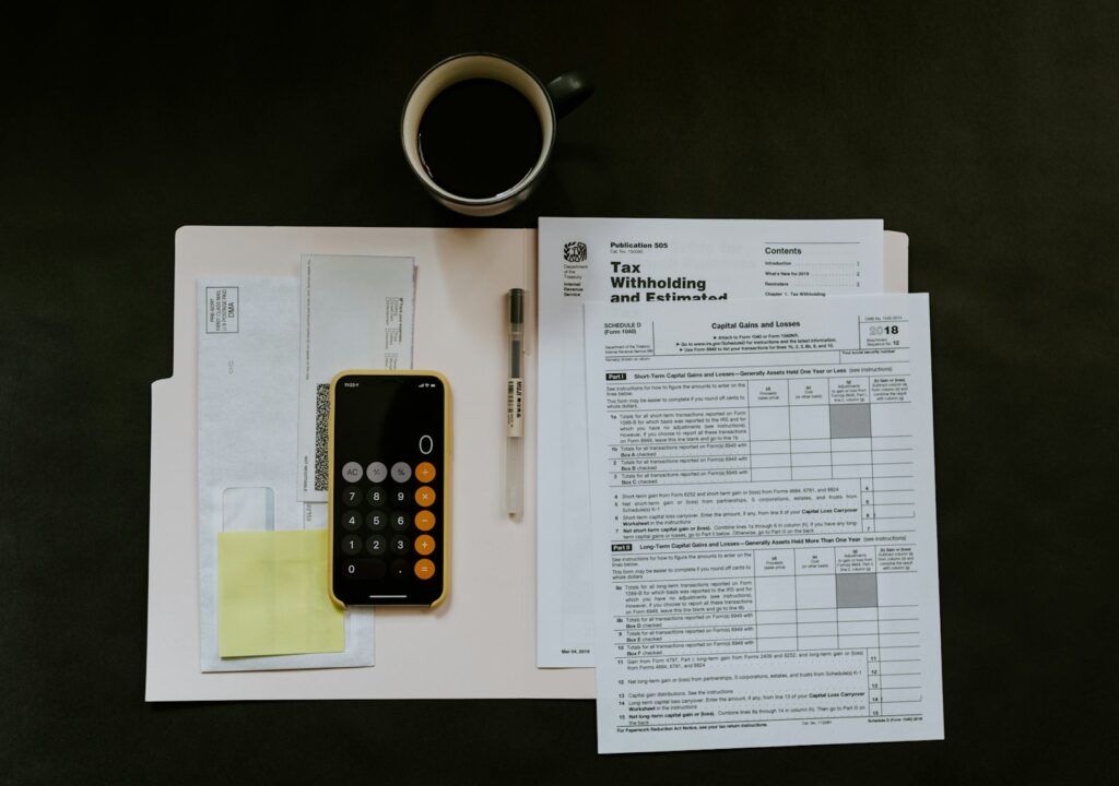Receipts, tax forms, and a calculator on a desk