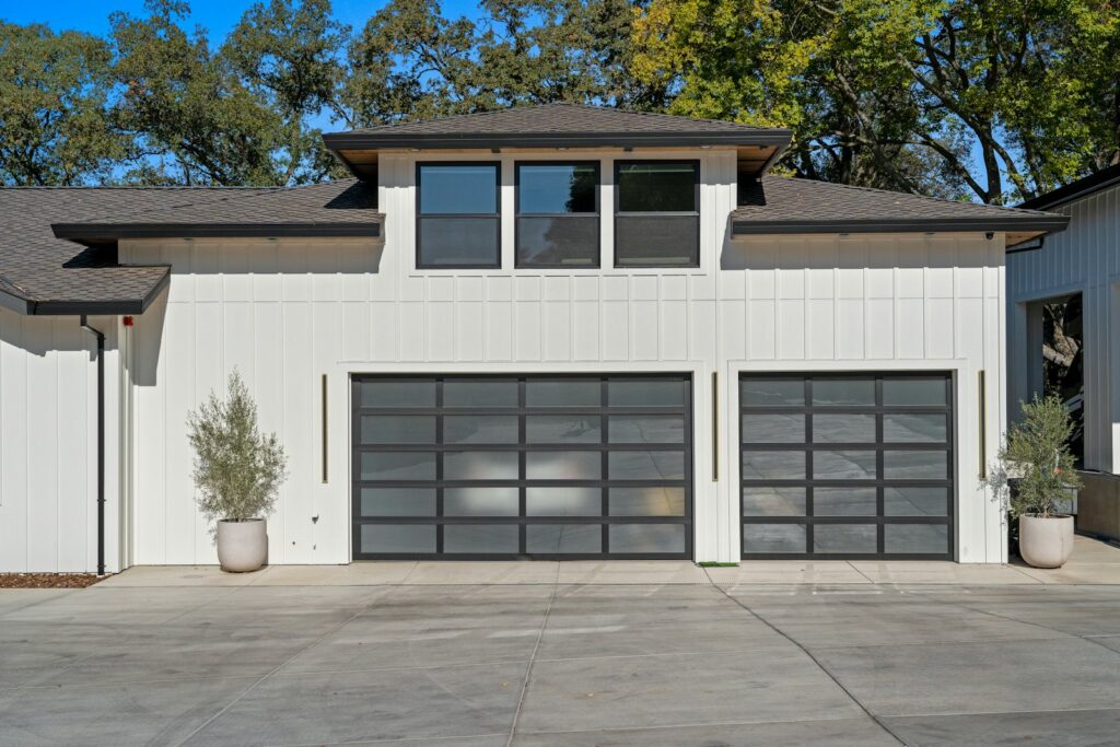 House with modern glass-panel garage doors