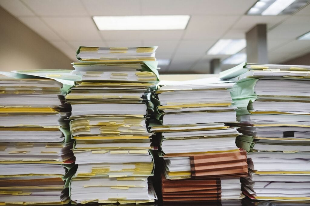 Stacks of paper files and binders in an office
